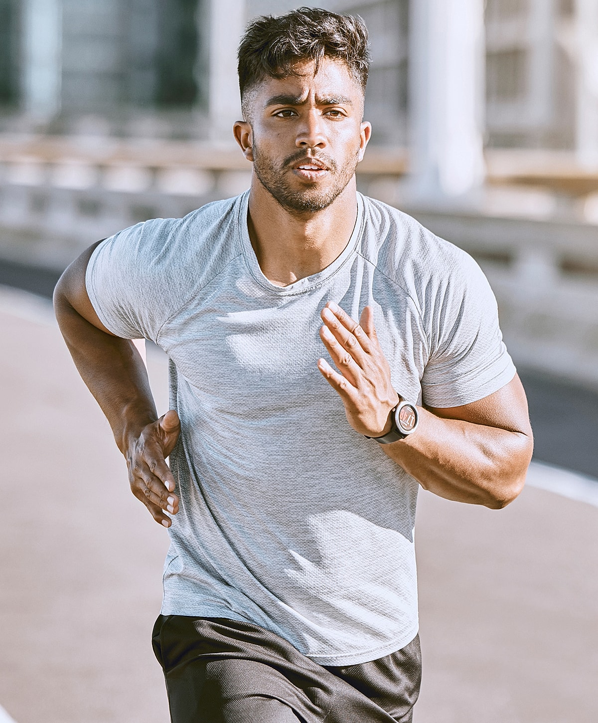 Man jogging outdoors in athletic clothing.