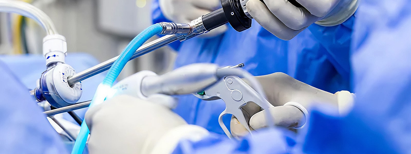 Surgeons using medical instruments in operating room.